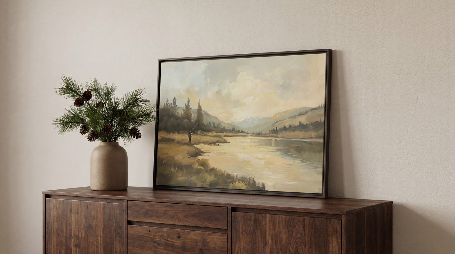 a wooden cabinet with a framed landscape painting hanging on it, placed on a white wall.