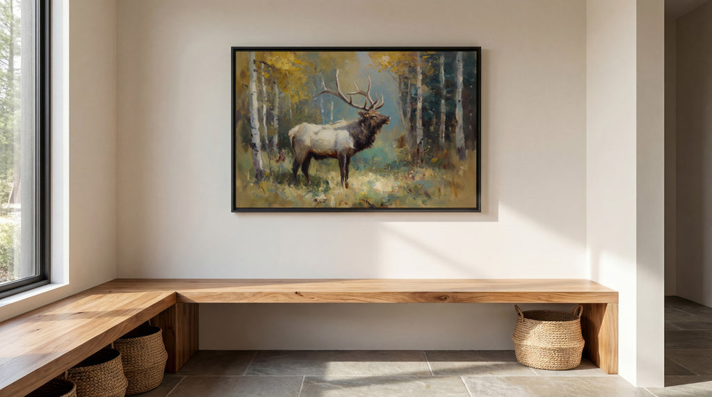 a large painting of a majestic elk standing in a forest, with its antlers reaching towards the sky. The painting is hung on a white wall above a wooden bench, which is situated in a room with a window and a basket on the floor.