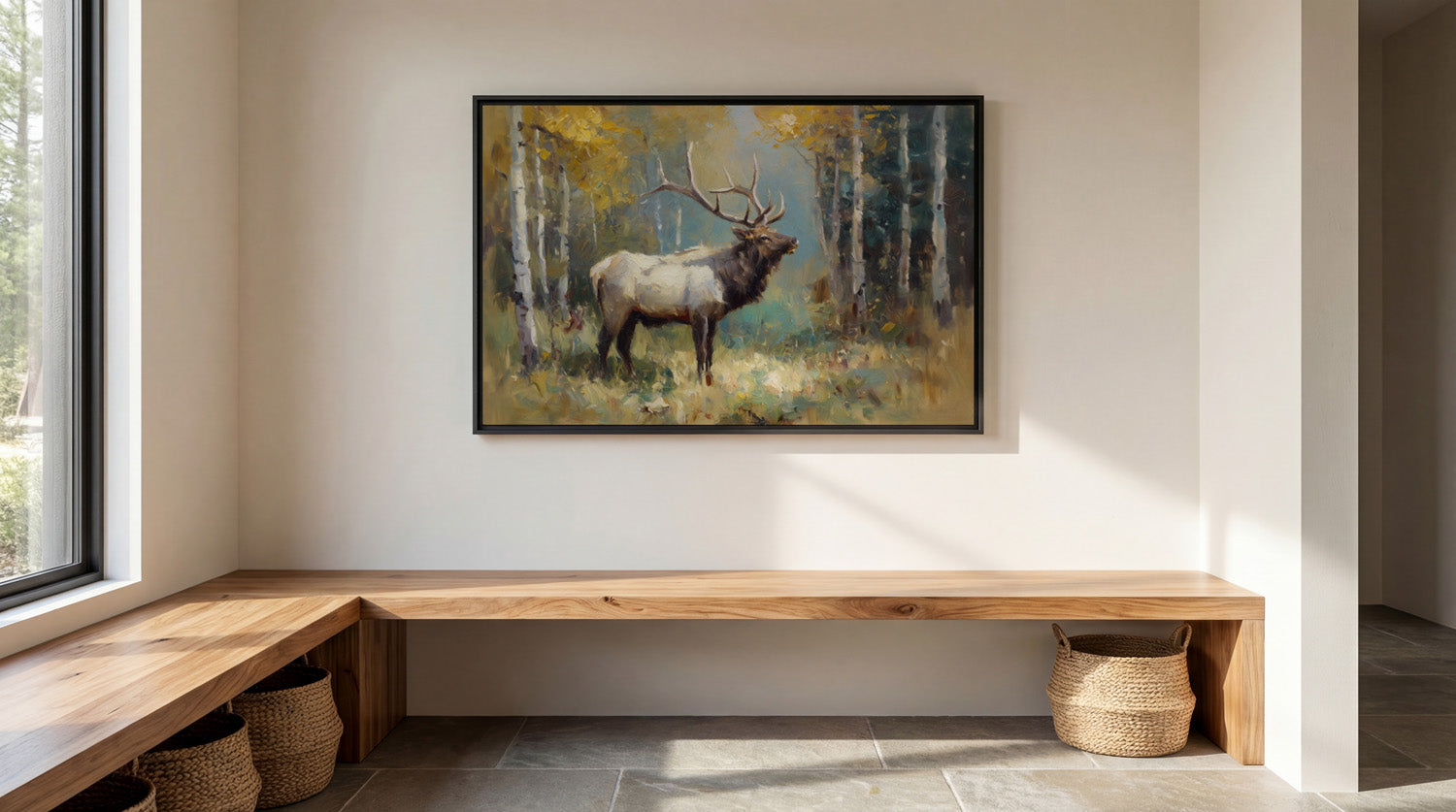 a large painting of a majestic elk standing in a forest, with its antlers reaching towards the sky. The painting is hung on a white wall above a wooden bench, which is situated in a room with a window and a basket on the floor.