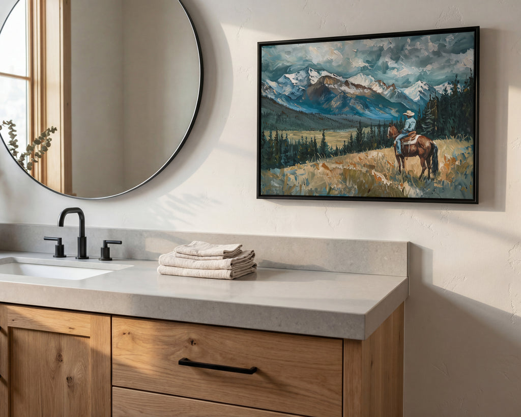 a bathroom scene with a large mirror, a wooden vanity, and a framed painting of a person riding a horse in a mountainous landscape.