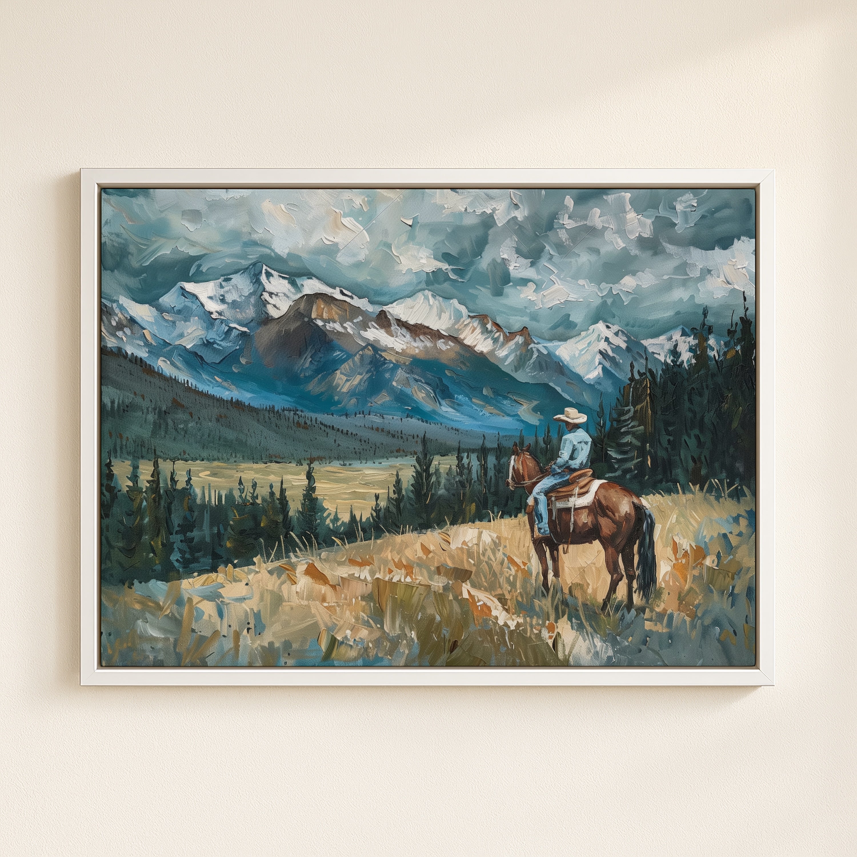 A cowboy on horseback stands in a grassy field, with snow-capped mountains and a cloudy sky in the background.