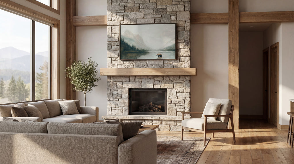 a spacious living room with a large stone fireplace, a comfortable sofa, a wooden coffee table, and a painting on the wall. The room has large windows that provide a scenic view of the mountains, creating a serene and inviting atmosphere.