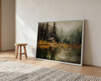 a large painting of a cabin on a lake, with a wooden stool and a rug in the foreground.