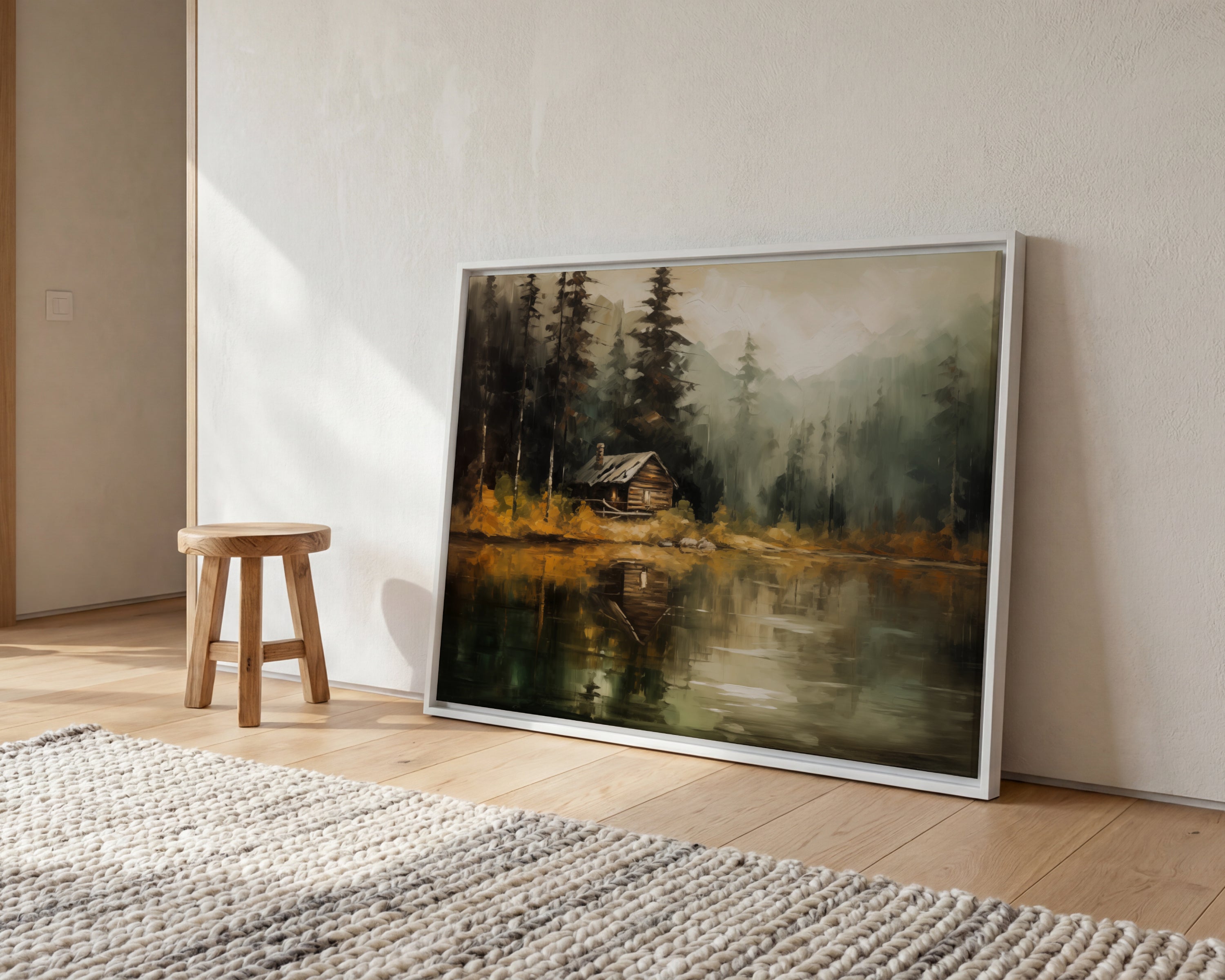 a large painting of a cabin on a lake, with a wooden stool and a rug in the foreground.