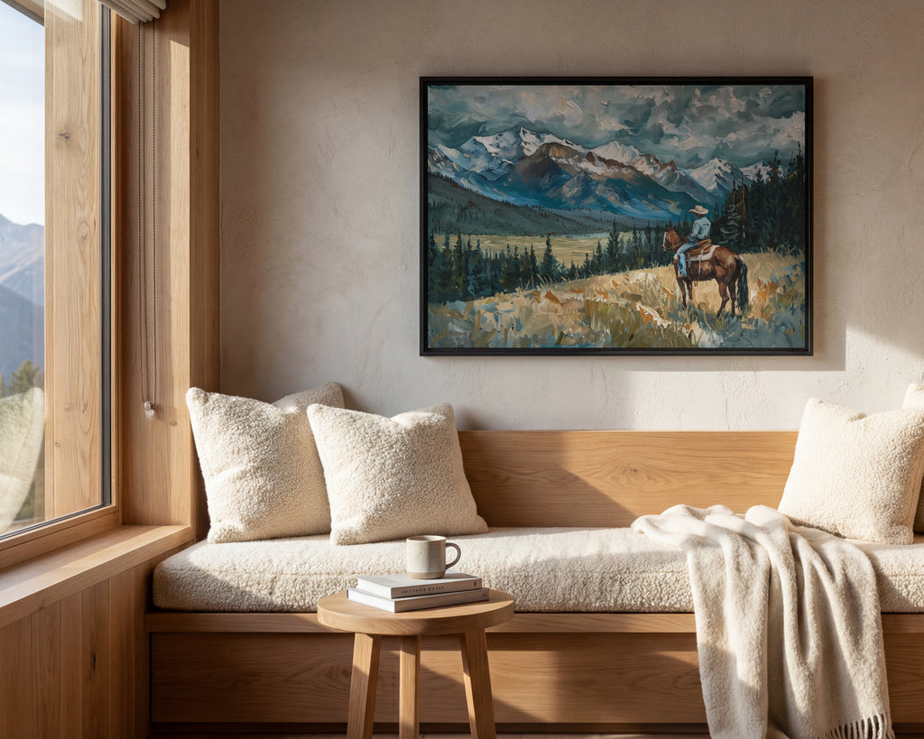 a cozy living room with a large window overlooking a picturesque mountain landscape. A painting of a person riding a horse is hanging on the wall, adding a rustic charm to the room. The room is furnished with a wooden bench, a small table with a book and a cup, and a plush white blanket draped over the bench.
