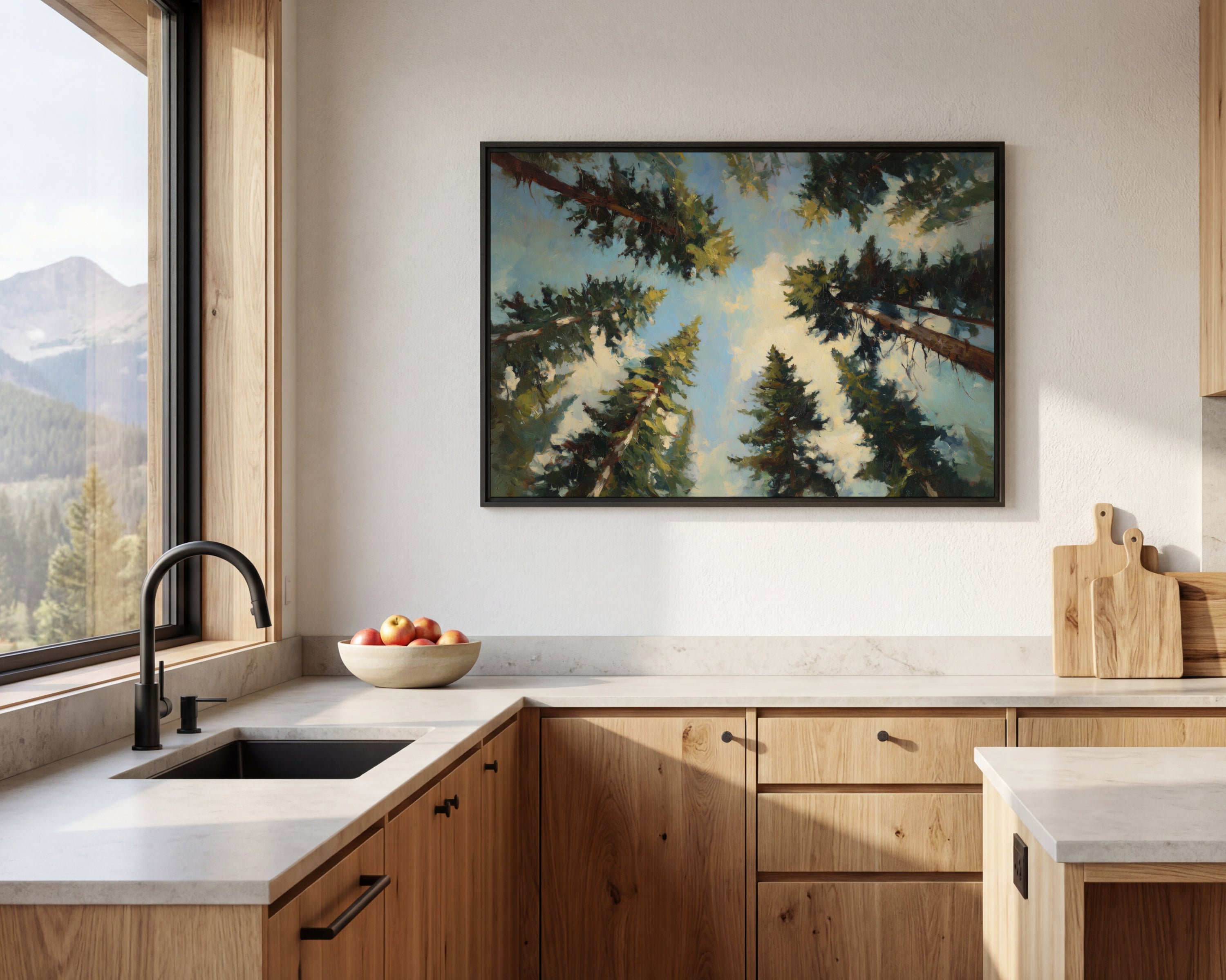a modern kitchen with a large window overlooking a scenic mountain landscape. The kitchen features wooden cabinets, a black sink, and a framed painting of trees on the wall above the sink.