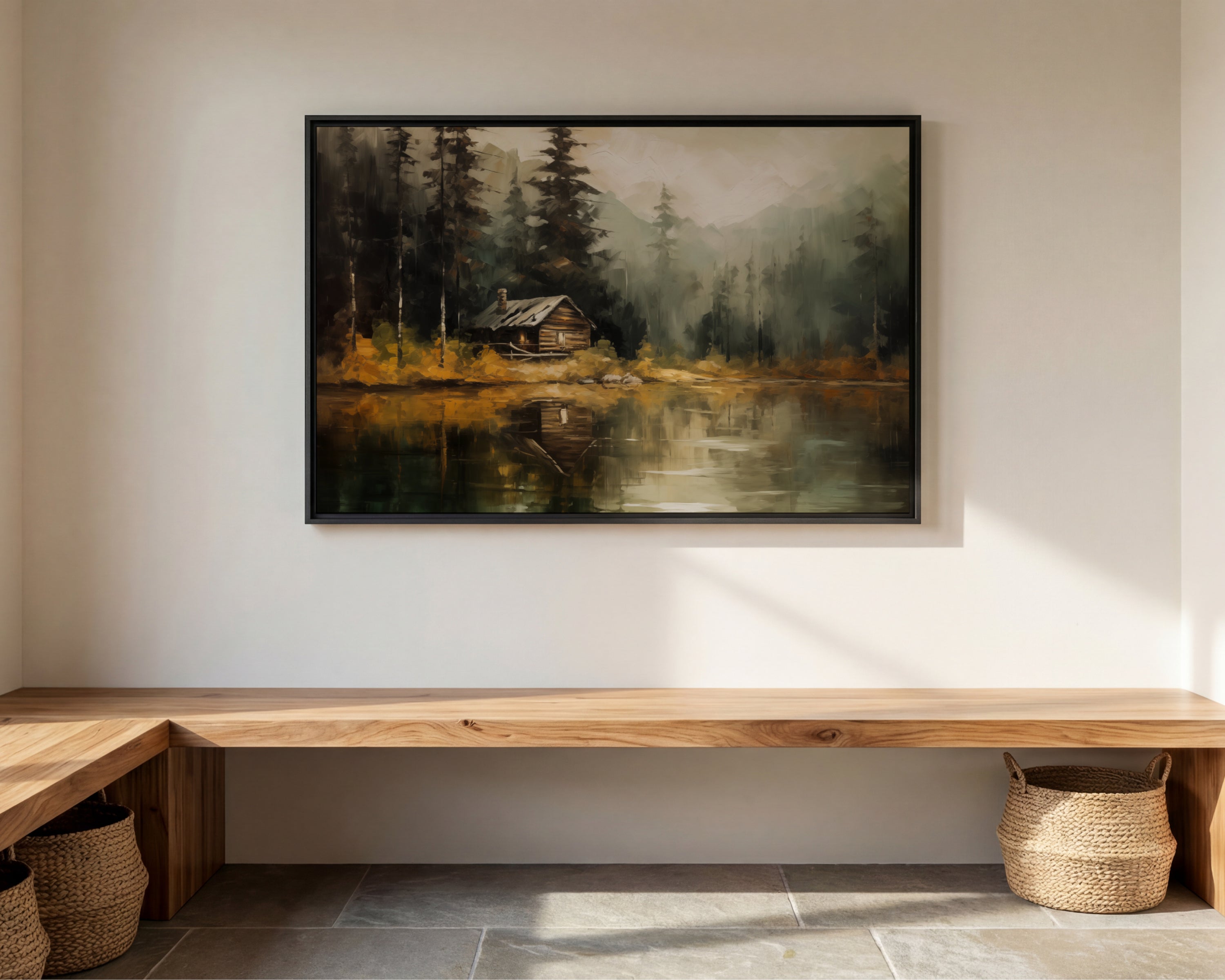 a wooden bench with a framed painting of a cabin and a lake hanging on the wall above it.