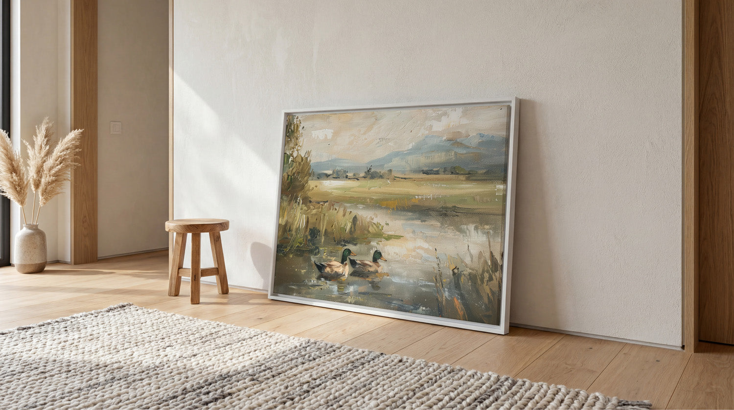 a large painting of ducks in a pond, hanging on a wall in a room with a wooden floor and a rug.
