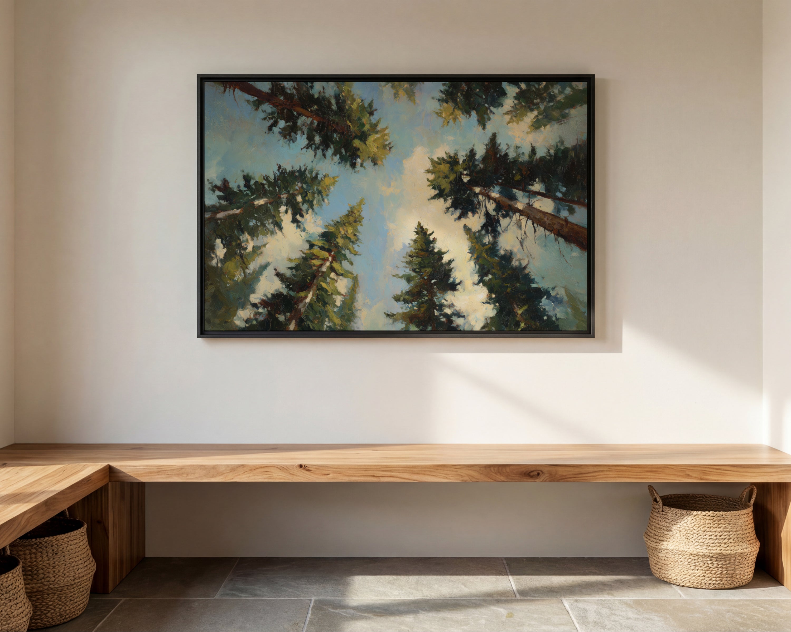 a large painting of a forest scene hanging on a white wall above a wooden bench.