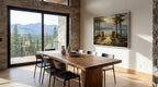 a modern dining room with a large wooden table and chairs, a painting of a scenic landscape on the wall, and a view of mountains through a large window.