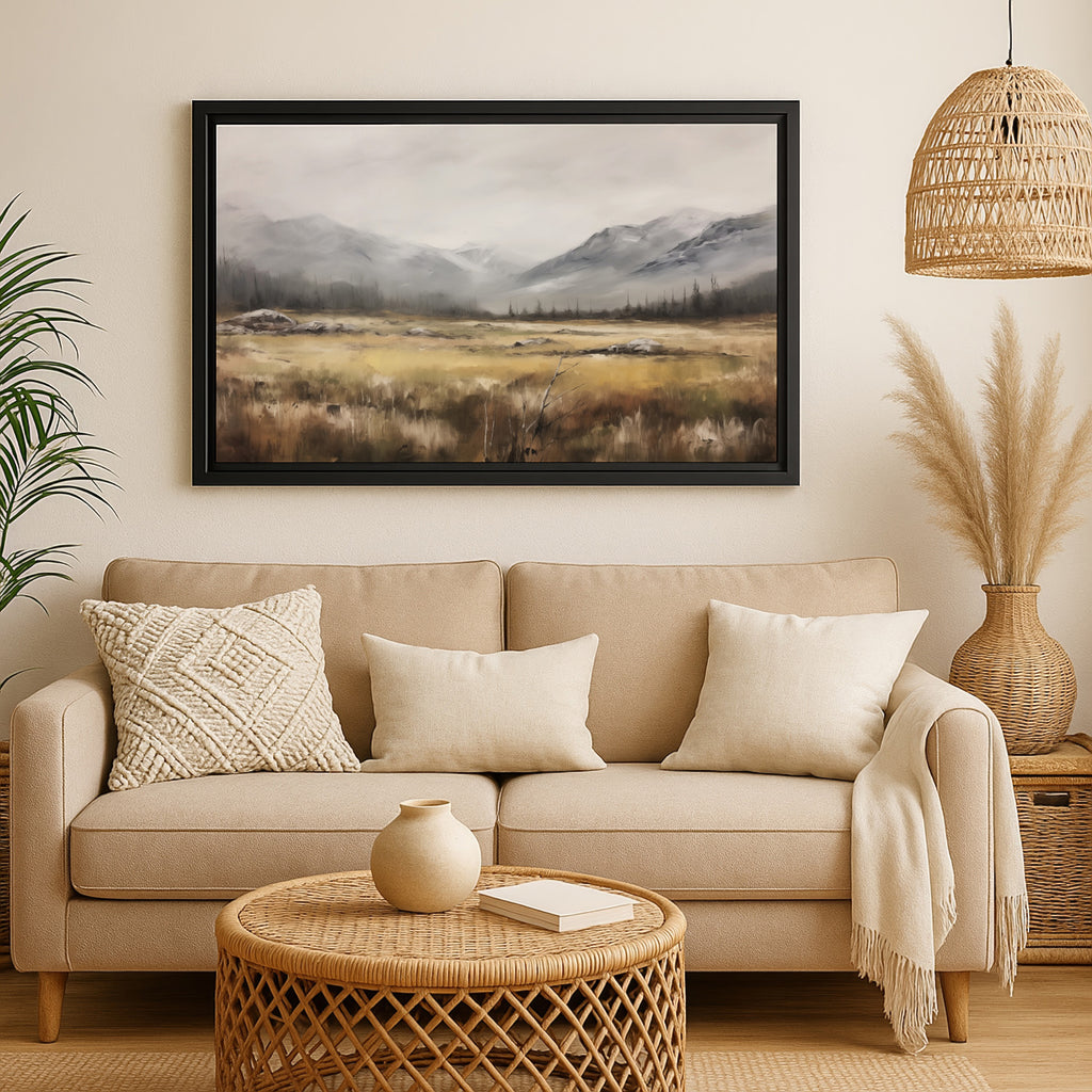 a cozy living room with a beige sofa, a woven coffee table, and a framed landscape painting hanging on the wall above the sofa.