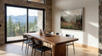 Dining area with wooden table and chairs, large window showing mountains, and wall art.