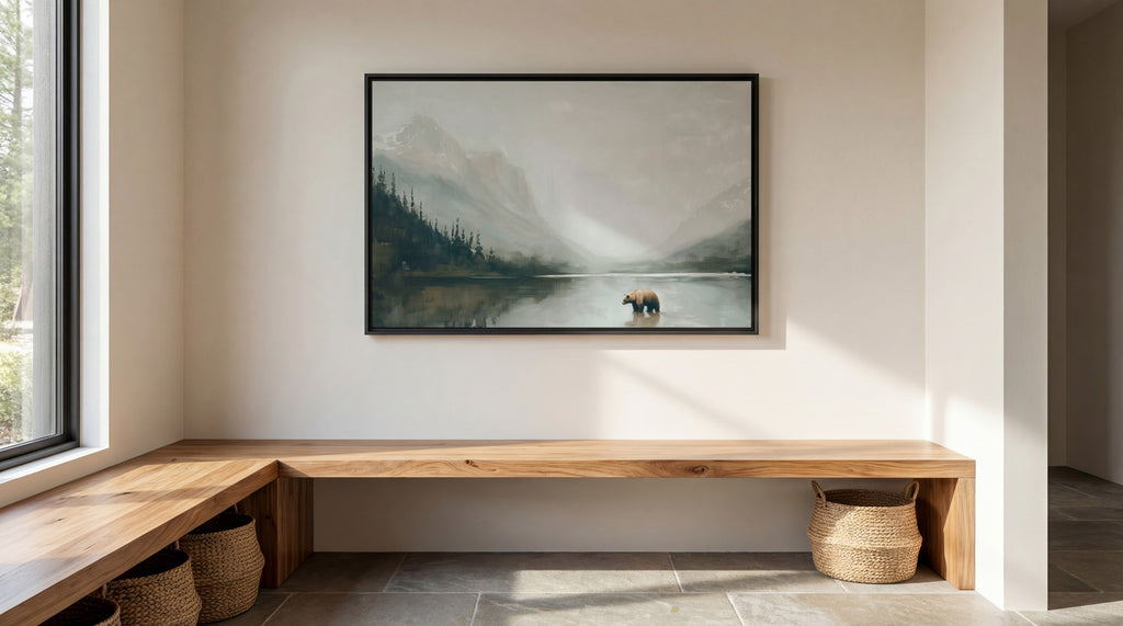 a serene indoor setting with a large painting of a bear in a lake hanging on the wall. The painting is framed in black and is the focal point of the room. The room has a wooden bench and a woven basket, creating a cozy and inviting atmosphere. The overall scene conveys a sense of tranquility and natural beauty.