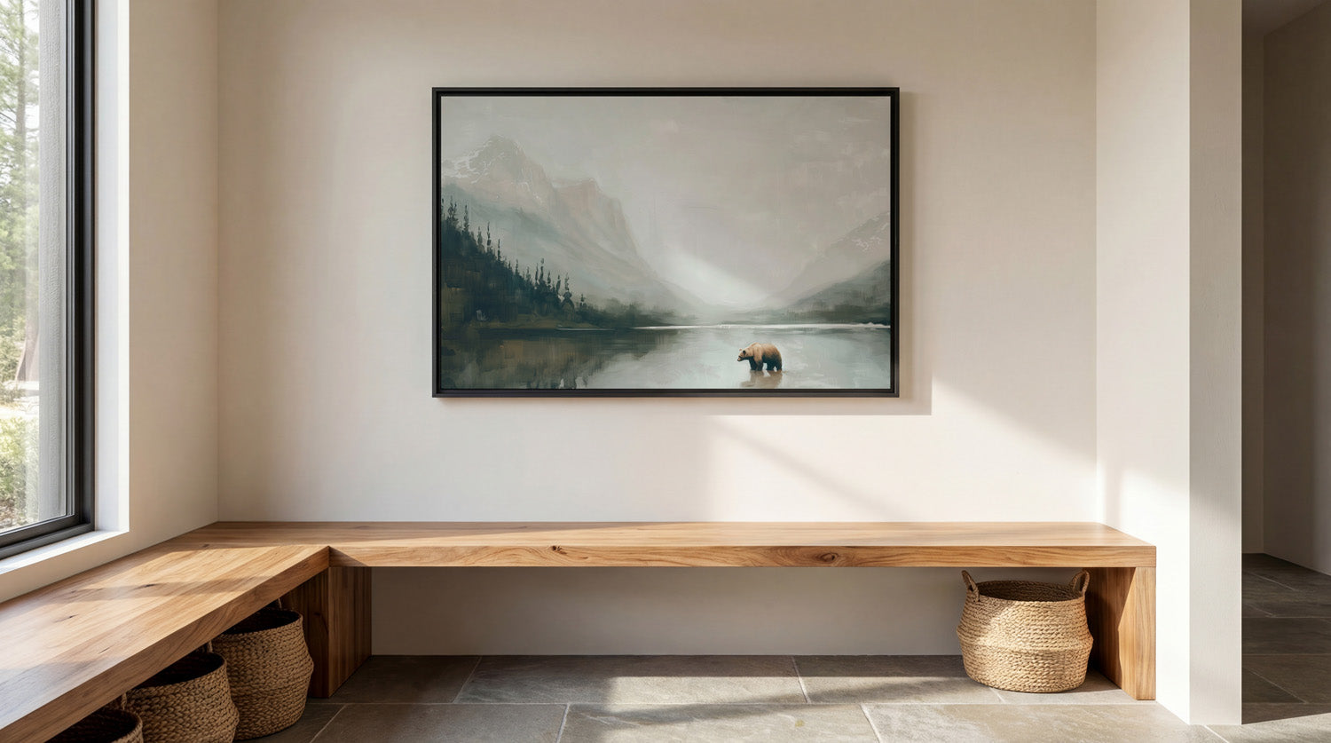 a serene indoor setting with a large painting of a bear in a lake hanging on the wall. The painting is framed in black and is the focal point of the room. The room has a wooden bench and a woven basket, creating a cozy and inviting atmosphere. The overall scene conveys a sense of tranquility and natural beauty.