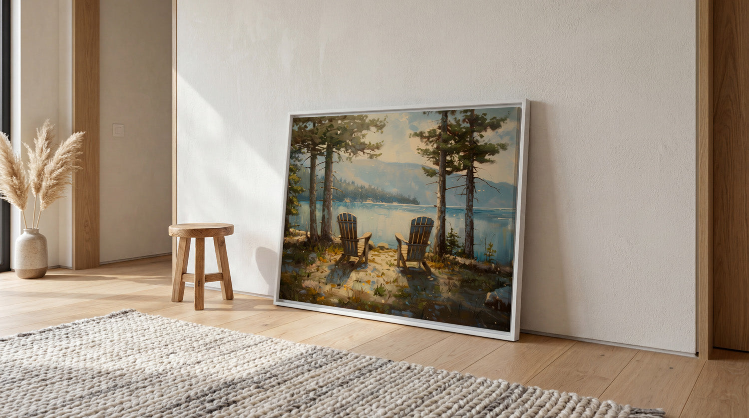 a large painting of a serene lakeside scene with two wooden chairs and a small table, set against a backdrop of trees and mountains.
