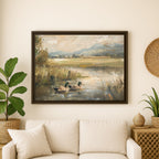 a large framed painting of ducks swimming in a pond, hanging on a wall above a white couch in a living room setting.