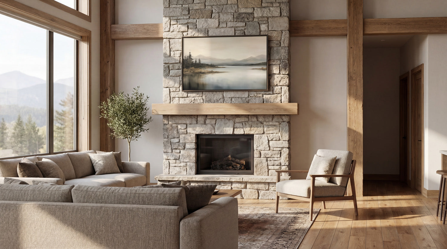 a spacious living room with a large stone fireplace, a comfortable sofa, a wooden coffee table, and a large window overlooking a scenic mountain landscape.