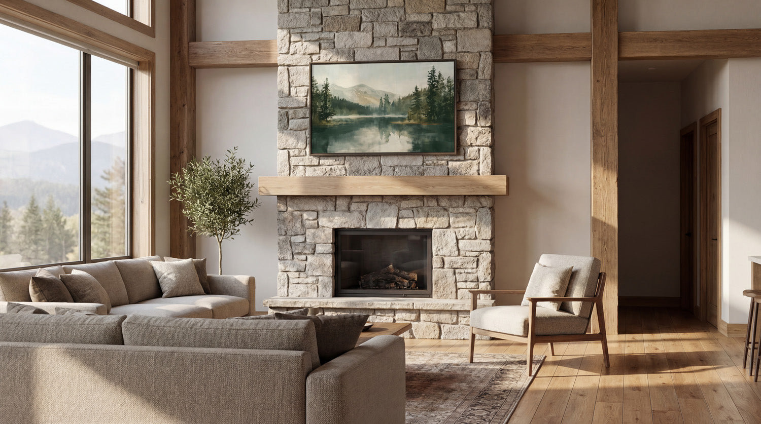 a cozy living room with a stone fireplace, a large window overlooking a scenic mountain landscape, and a comfortable seating arrangement with a couch and a chair.